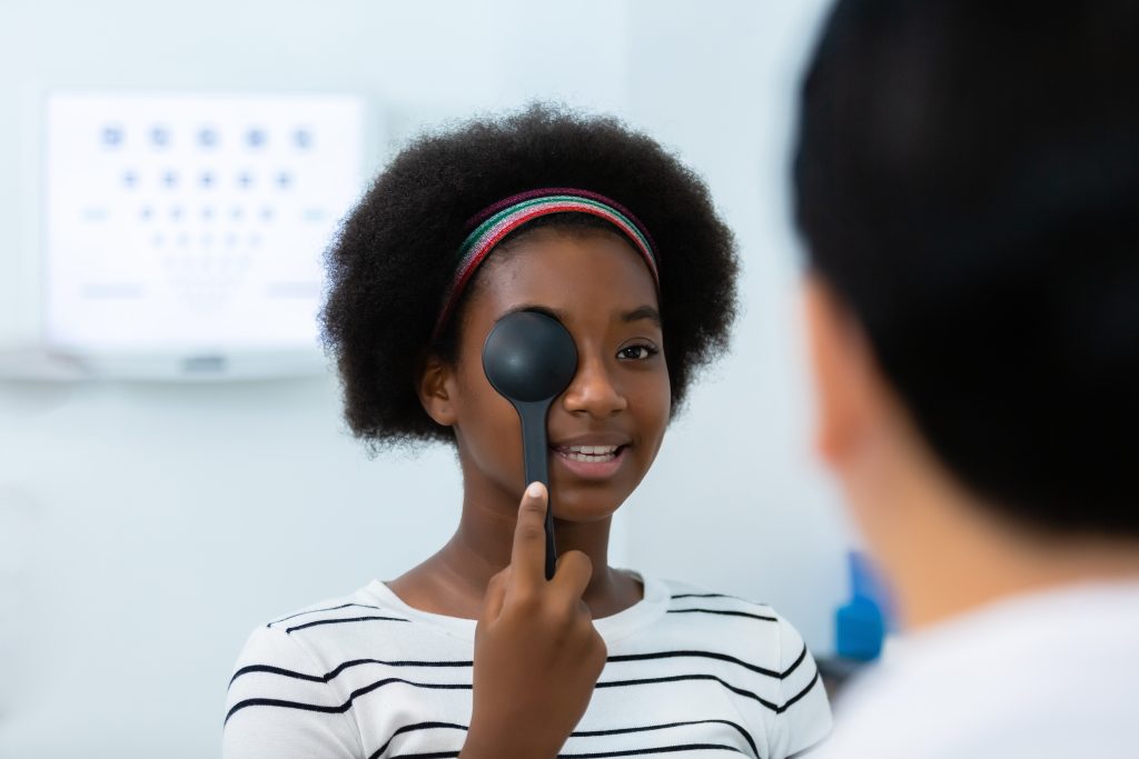 eine Frau macht einen Cover-Test bei einem Augenarzt